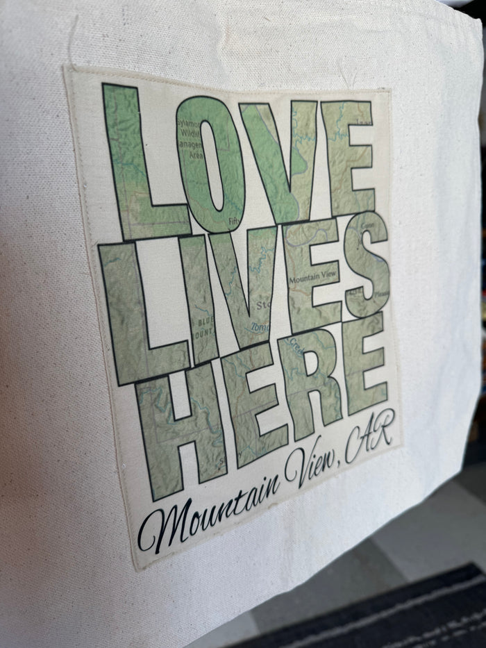 love lives here tote in a store