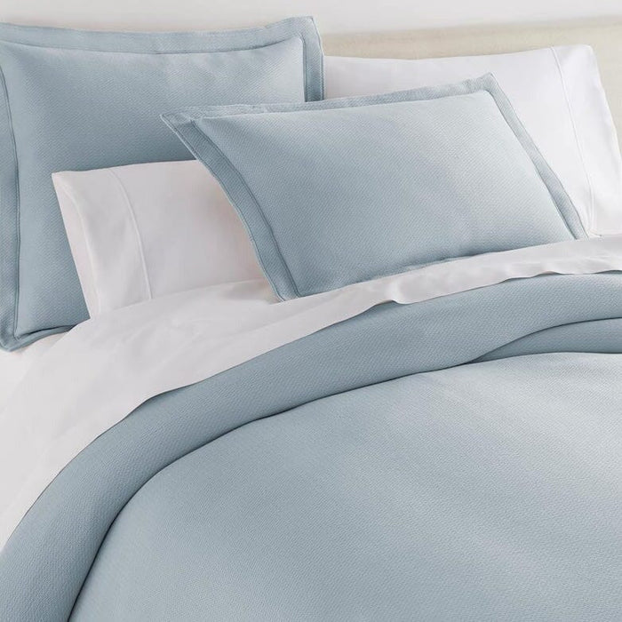 Peacock Alley Angie Blue Stonewashed Matelassé Coverlet and Pillow Shams with White Sheets