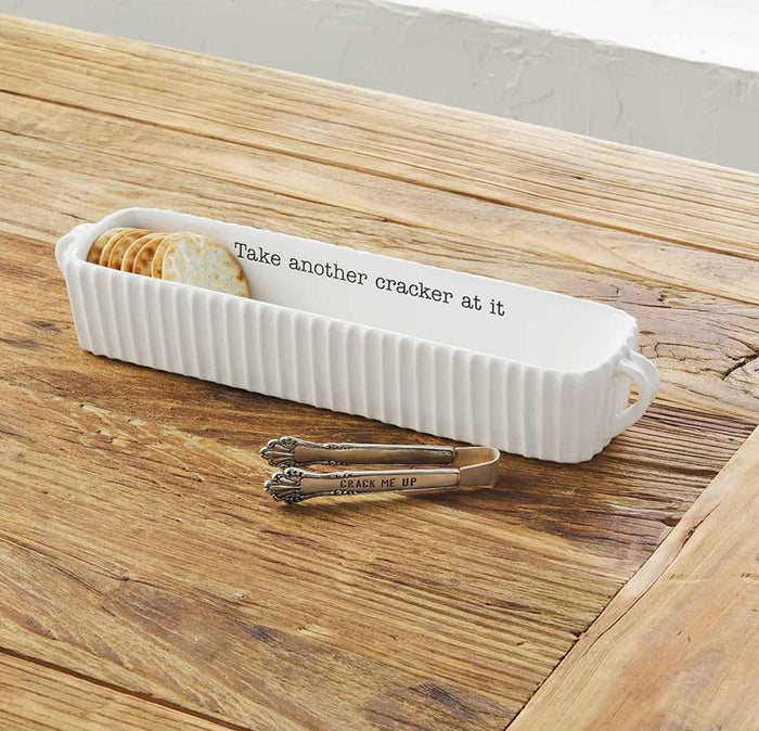 White cracker holder with crackers on a wooden surface
