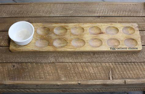 Wooden egg tray with compartments on a rustic wooden surface