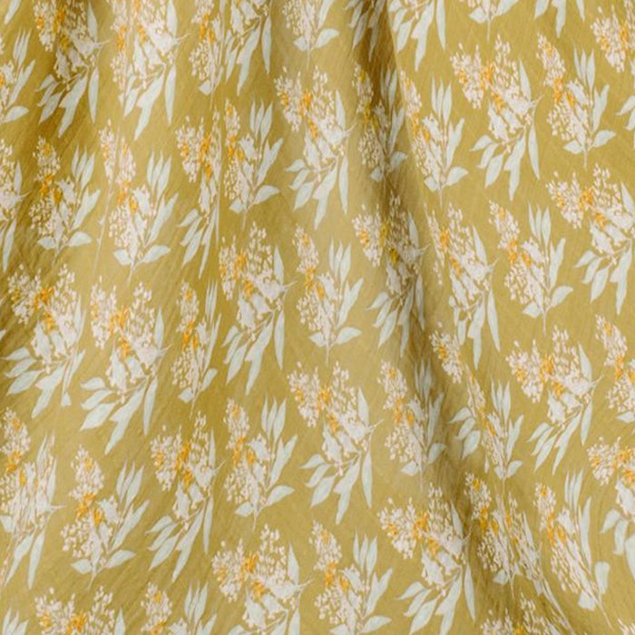 burts bee baby gold floral swaddle on a white background close up