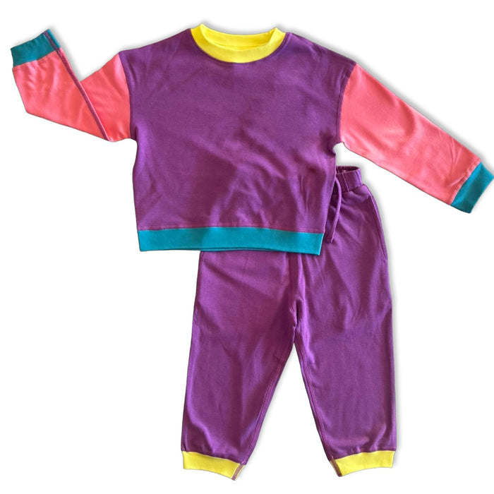 Children's purple and pink outfit with teal and yellow accents on a white background