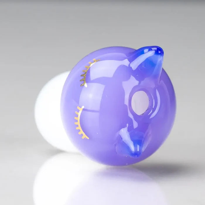 Purple Sakibomb kitty head carb cap with gold lashes and blue nose