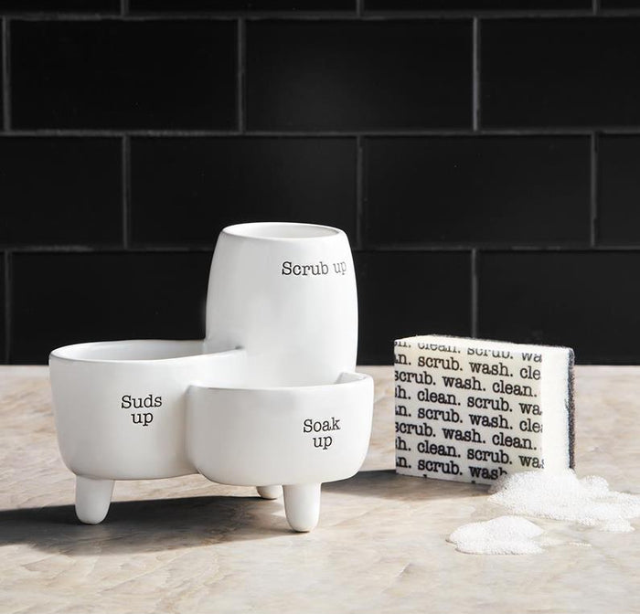 Set of white ceramic containers with text on a wooden surface and black tiled wall background