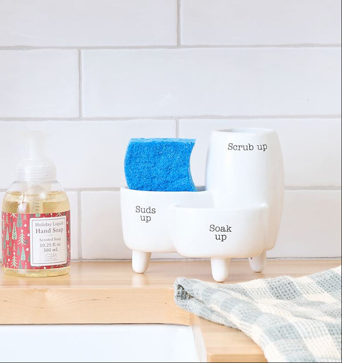 Kitchen sink area with a faucet, soap bottle, and cleaning products on a wooden countertop.