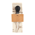 Black stuffing baster with a decorative label on a white background