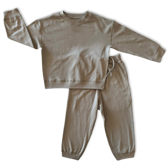 Beige sweatshirt and pants set on a white background